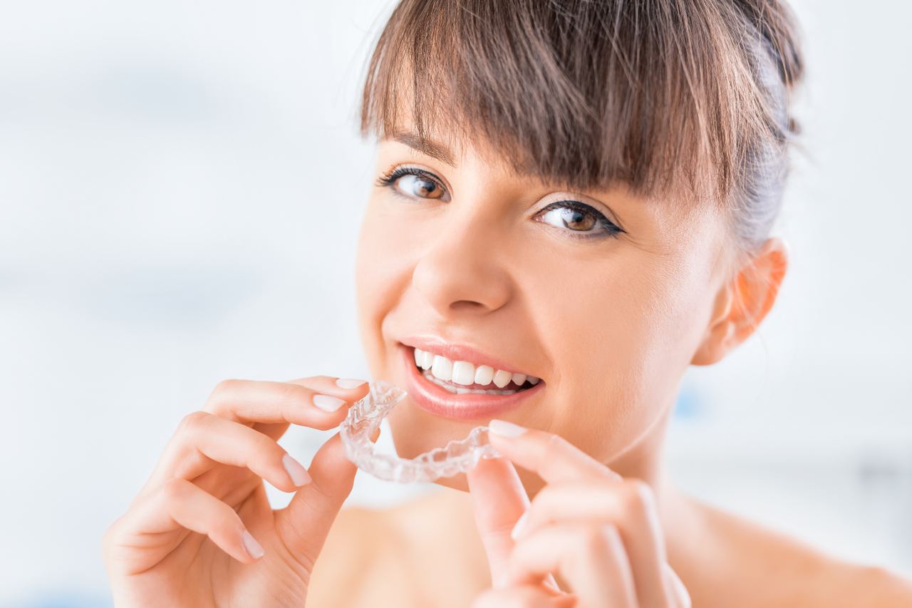 Beautiful smile and white teeth of a young woman with invisalign clear braces